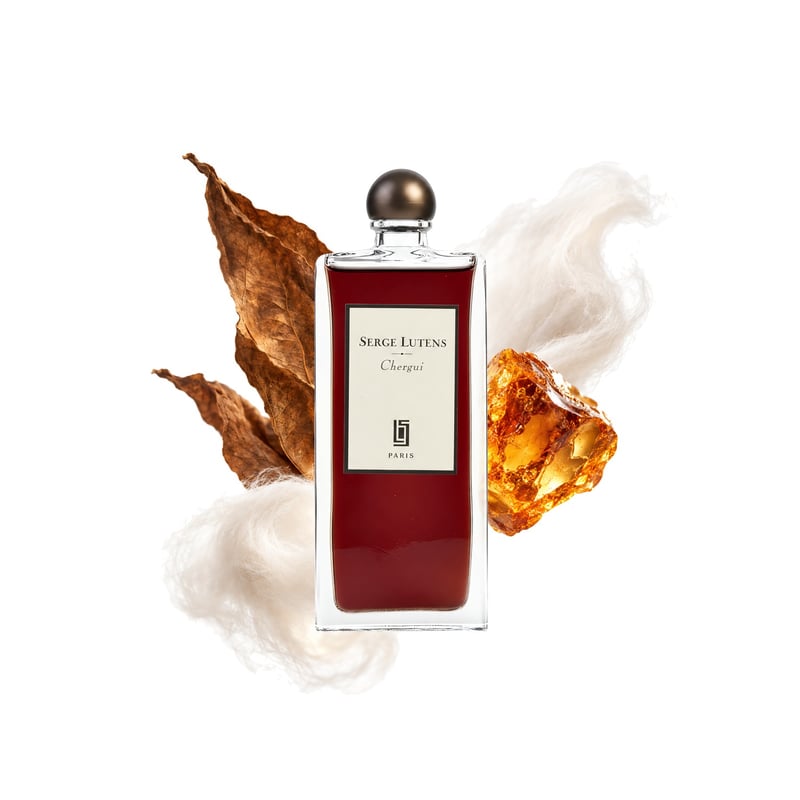 Chergui by Serge Lutens, bottle pictured with its key notes: Amber, Tobacco Leaf and Musk