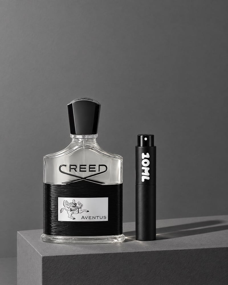 Creed Aventus beside a 10ML travel atomiser on a grey plinth