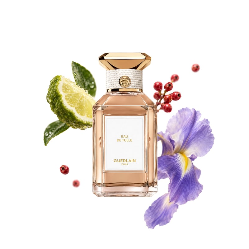 Eau de Tulle by Guerlain, bottle pictured with its key notes: Bergamot, Pink Pepper and Iris