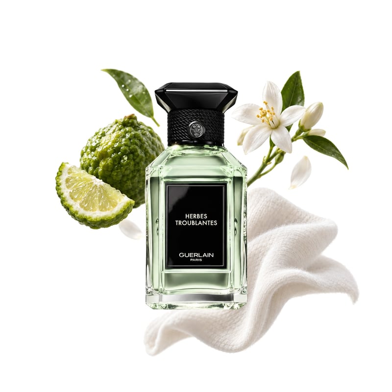 Herbes Troublantes by Guerlain, bottle pictured with its key notes: Bergamot, Orange Blossom and White Musk