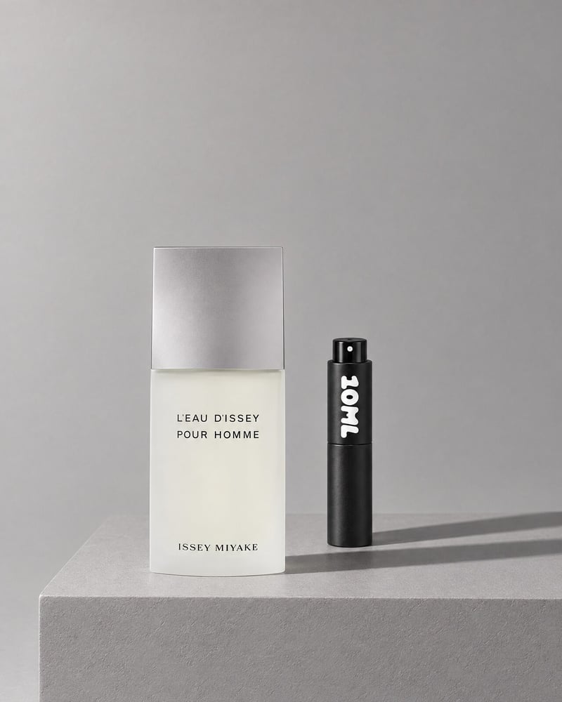 Issey Miyake L'Eau d'Issey Pour Homme beside a 10ML travel atomiser on a grey plinth