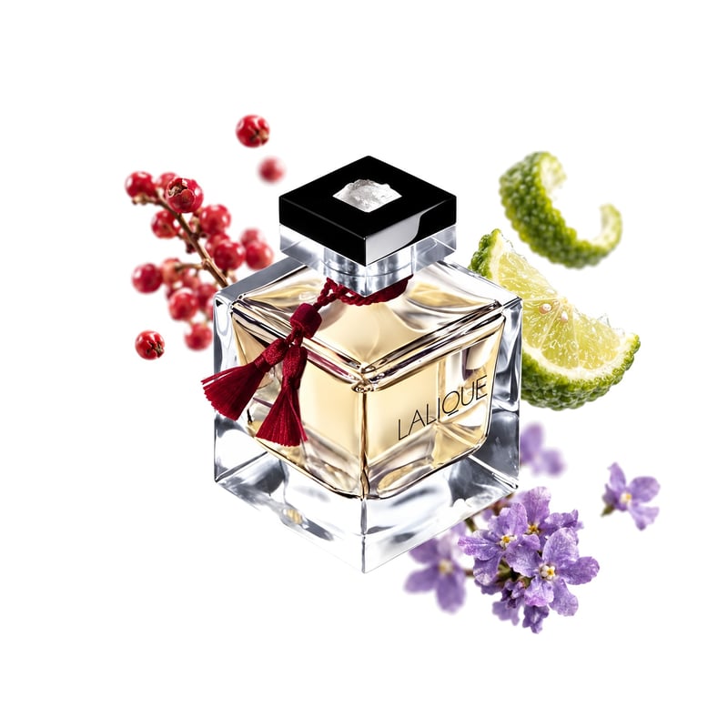 Le Parfum by Lalique, bottle pictured with its key notes: Pink Pepper, Bergamot and Heliotrope
