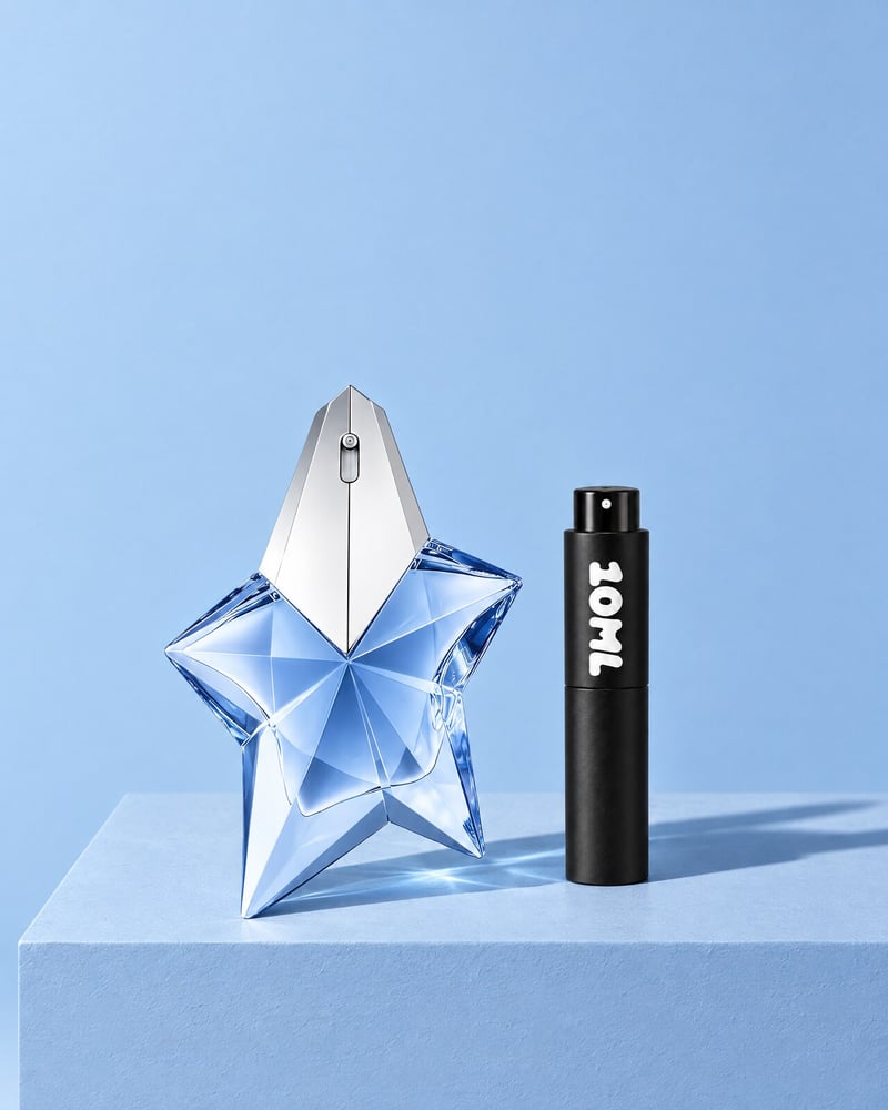 Mugler Angel beside a 10ML travel atomiser on a blue plinth