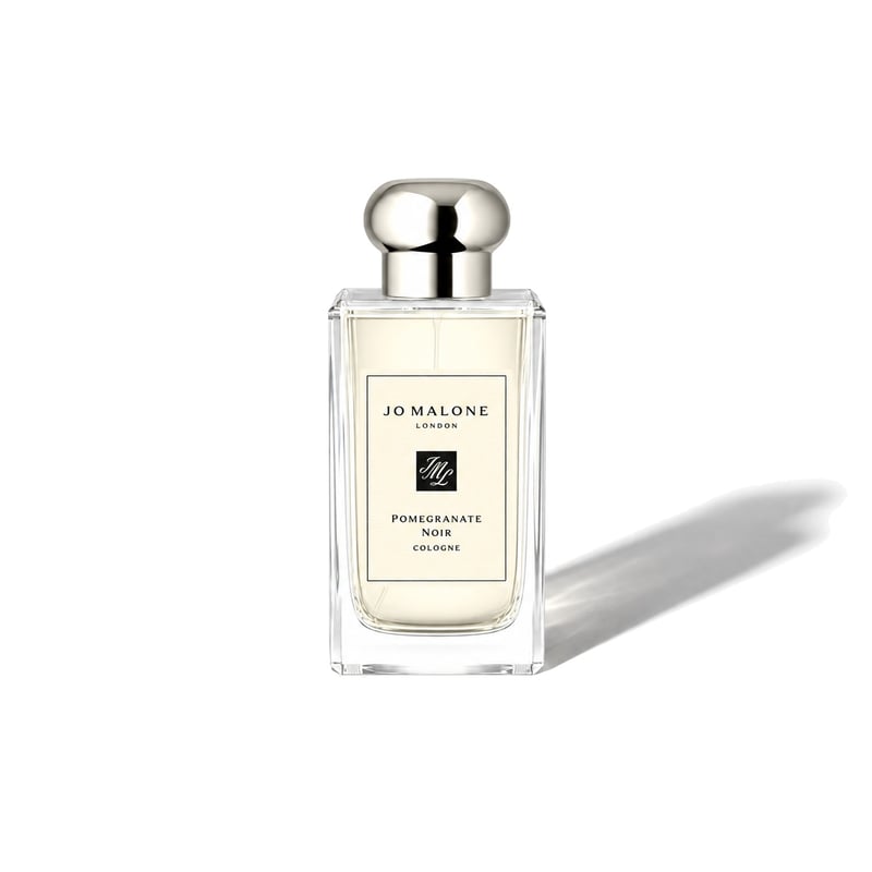 Pomegranate Noir by Jo Malone London, bottle casting a soft shadow