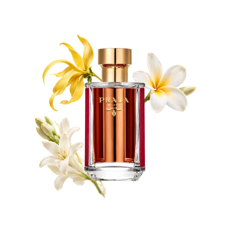Prada La Femme Intense by Prada, bottle pictured with its key notes: Ylang-ylang, Frangipani and Tuberose