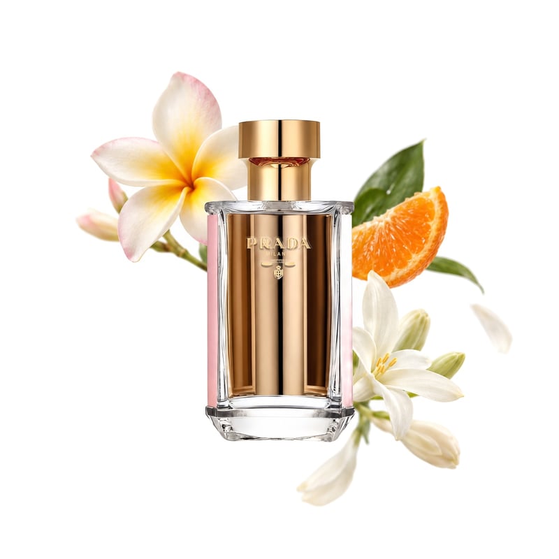 Prada La Femme L'Eau by Prada, bottle pictured with its key notes: Frangipani, Mandarin Orange and Tuberose